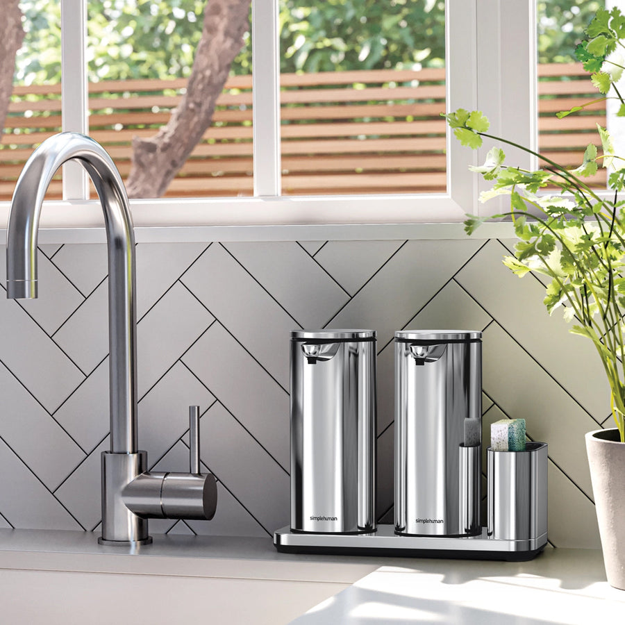 Simplehuman Polished Stainless Steel Dual Caddy with two 14 oz sensor pumps by kitchen sink, offering hands-free organization.