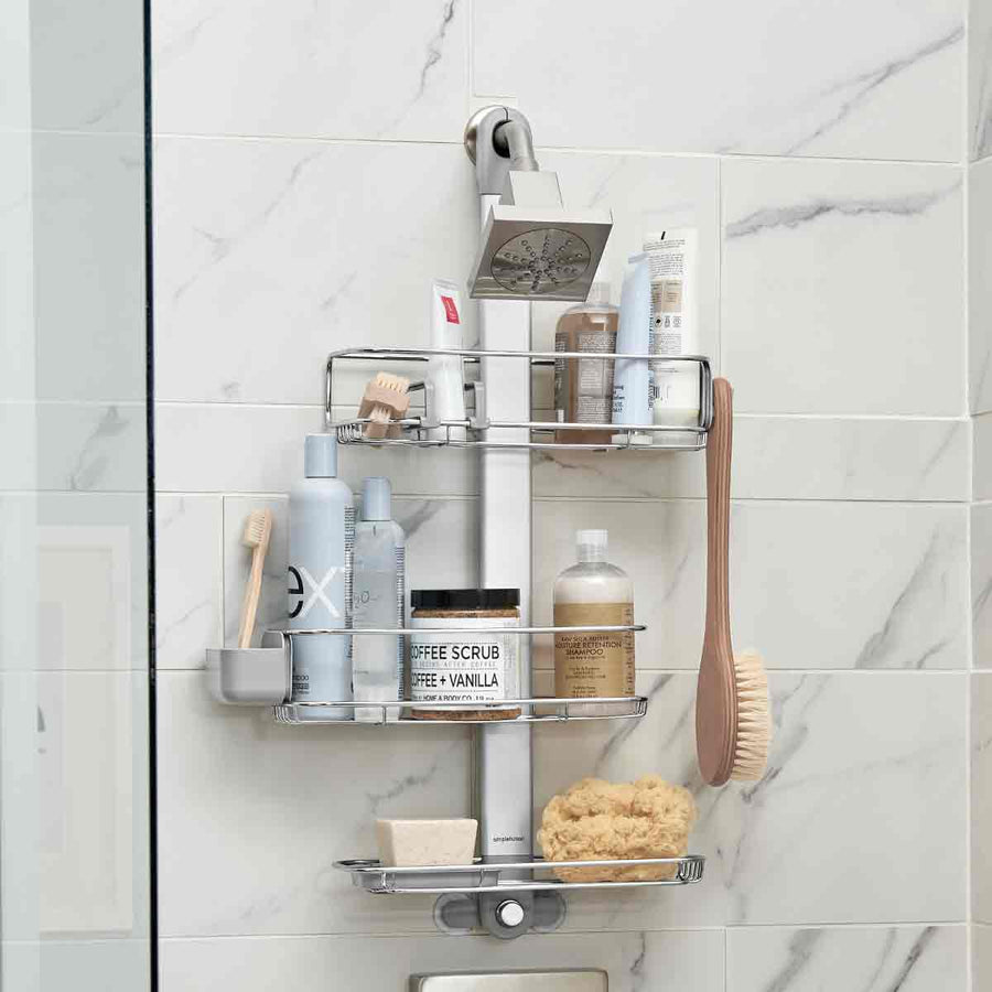Simplehuman Polished Stainless Steel Adjustable Shower Caddy, fully loaded, showing quick-dry shelves and specialized storage attachments.