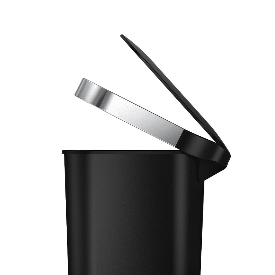 Detail view of Simplehuman 40L Slim Step Can, Matte Black Plastic, showing the open lid and Brushed Stainless Steel liner rim.