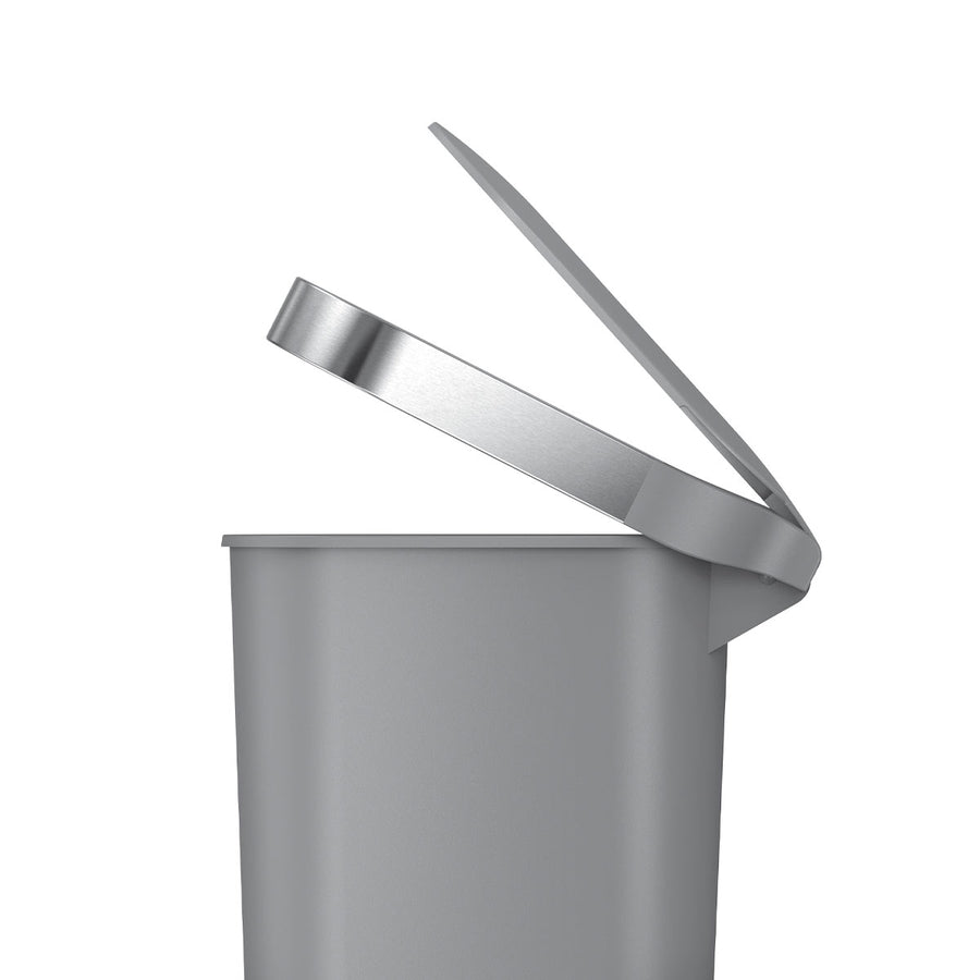 Side profile view: Simplehuman 40L Slim Step Can in Grey Plastic with open lid and Brushed Stainless Steel liner rim.
