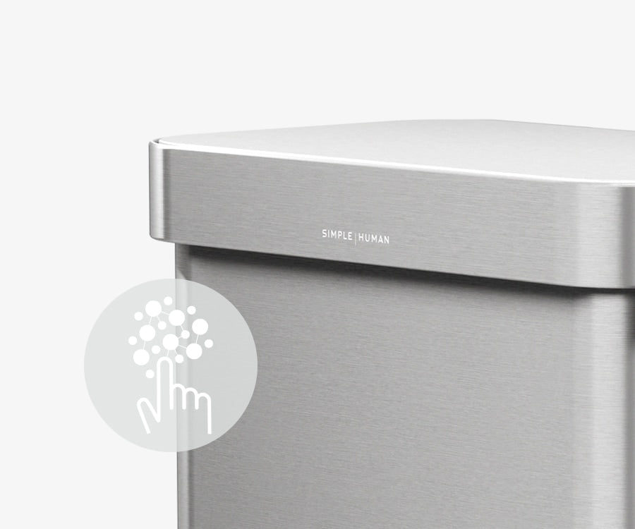 This image of Simplehuman's 58L Step Can in Brushed showcases an icon describing how the can has a silver ion-coating that resists both fingerprints and the spread of germs.