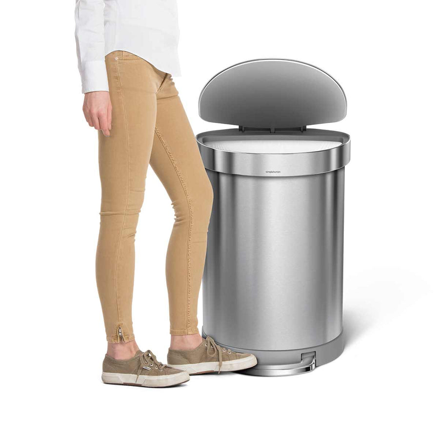 Lifestyle view of Simplehuman 60L Step Can, Brushed Stainless Steel, hands-free operation with Liner Rim.
