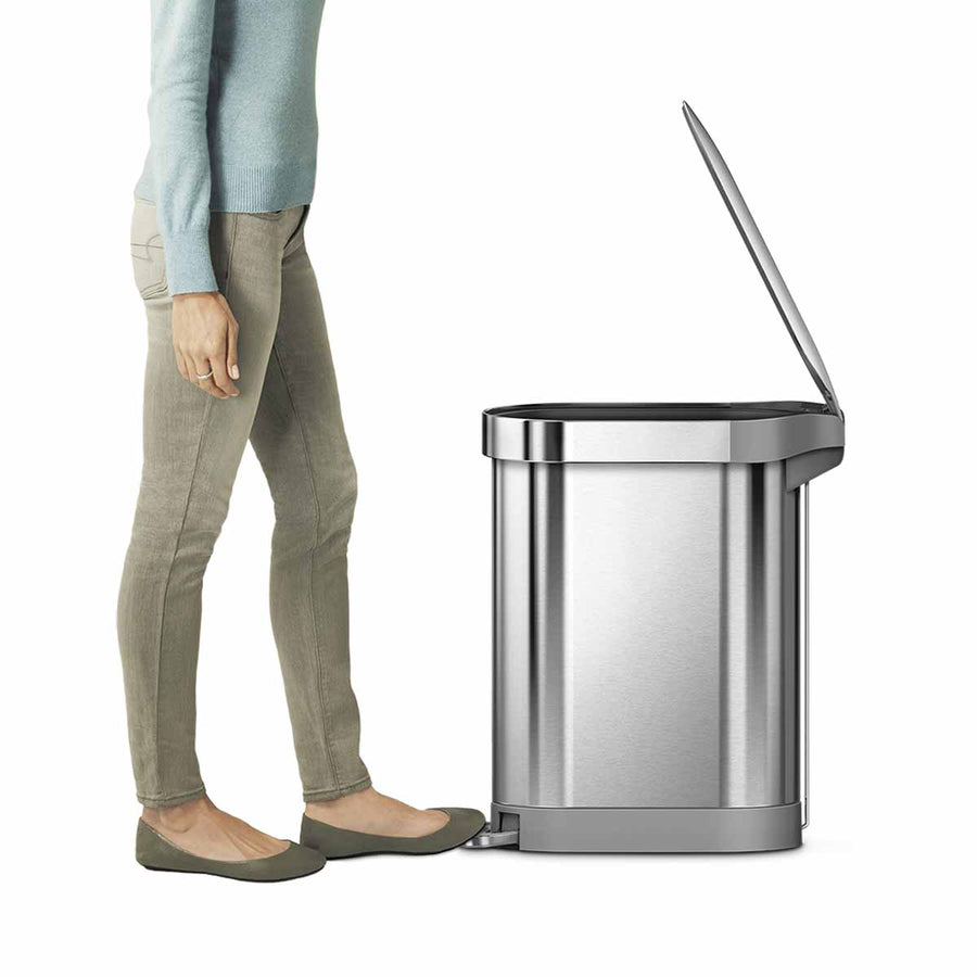 Lifestyle view of Simplehuman 45L Slim Step Can in Brushed Stainless Steel, demonstrating hands-free operation.