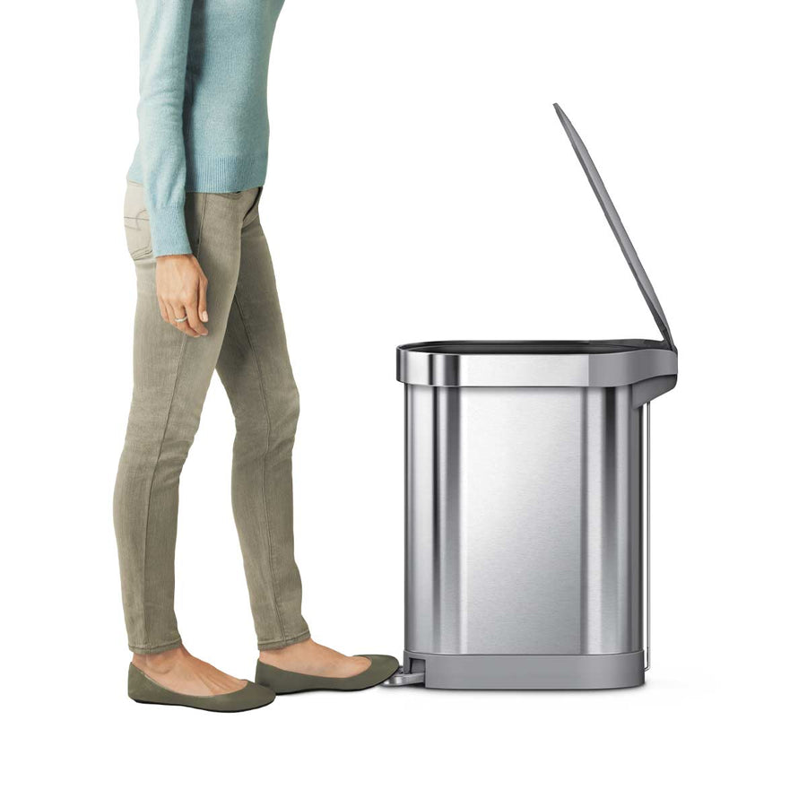 Side view: Simplehuman 45L Slim Step Can, Brushed Stainless Steel, demonstrating hands-free step pedal use.