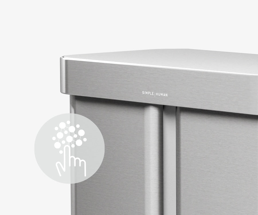 This image of Simplehuman's 90L Step Can in Brushed showcases an icon describing how the can has a silver ion-coating that resists both fingerprints and the spread of germs.