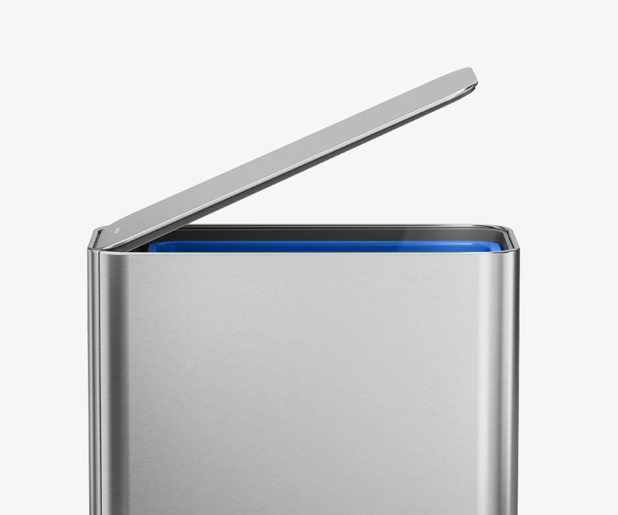 Simplehuman's Slim Step Can in Brushed with the lid opened slightly showcasing the sleek design with a hidden compartment in the can for swift and easy trash disposal.