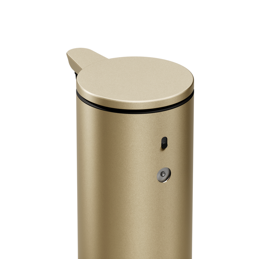 High-angle close-up of Simplehuman 9 oz. Sensor Pump in Brass, showing dosage dial and power switch.