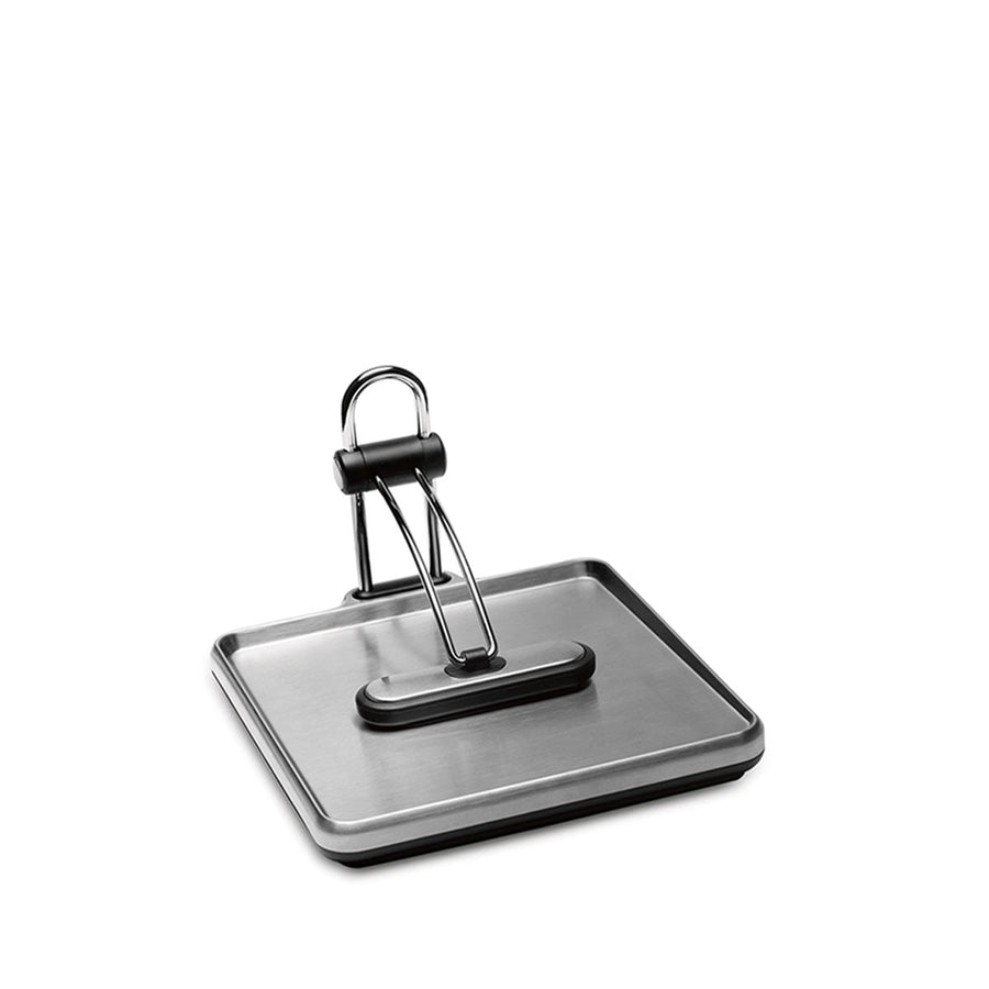 Angled view, Simplehuman Quick Grip Napkin Holder in Brushed Stainless Steel with weighted black arm for secure dispensing.
