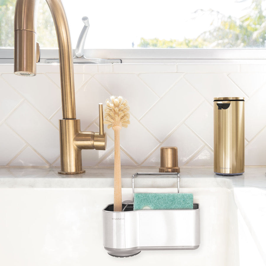 Simplehuman Brushed Stainless Steel Sink Caddy organizing sponge and brush inside sink basin, space-saving design.