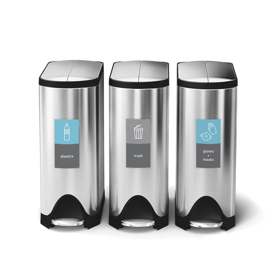 Front view of three Simplehuman Brushed Stainless Steel Step Cans using Magnetic Sorting Labels (plastics, trash, gloves + masks).