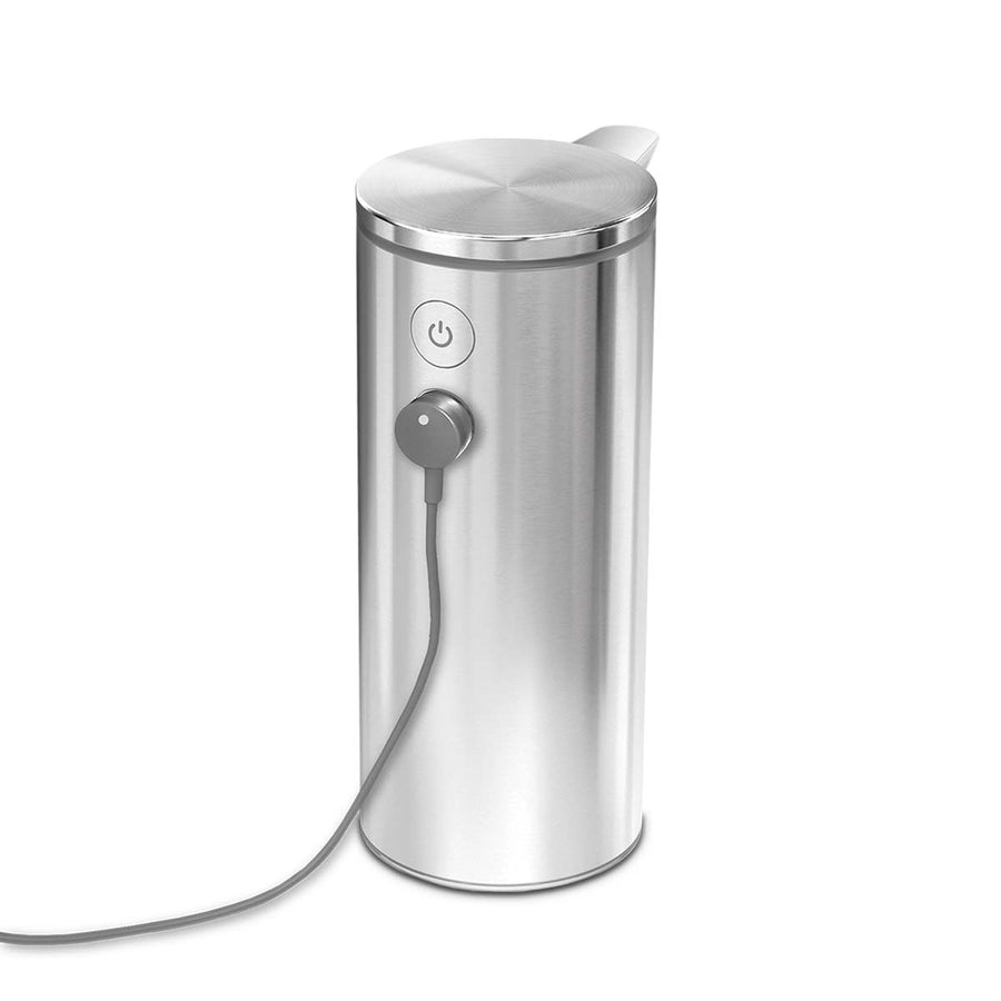 Close-up of Simplehuman 9 oz. Rechargeable Sensor Pump, Brushed Stainless Steel, showing magnetic charger connected for quick recharge.