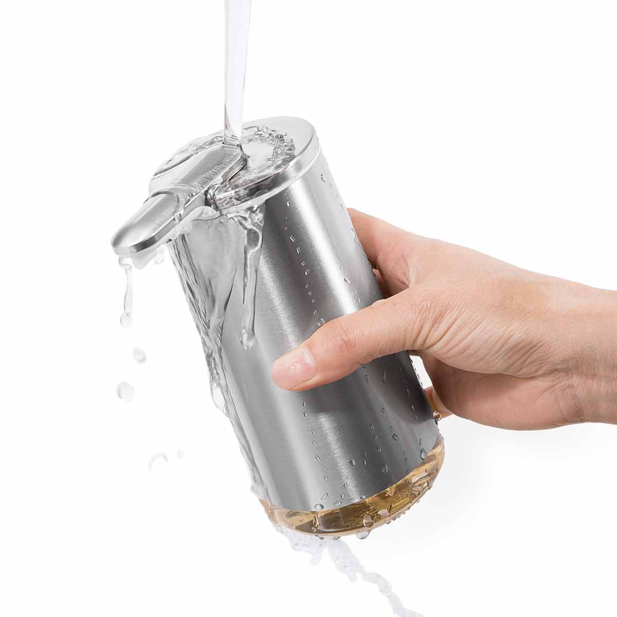 Angled view of Simplehuman Brushed Stainless Steel Foam Sensor Pump being washed, waterproof for easy cleaning.