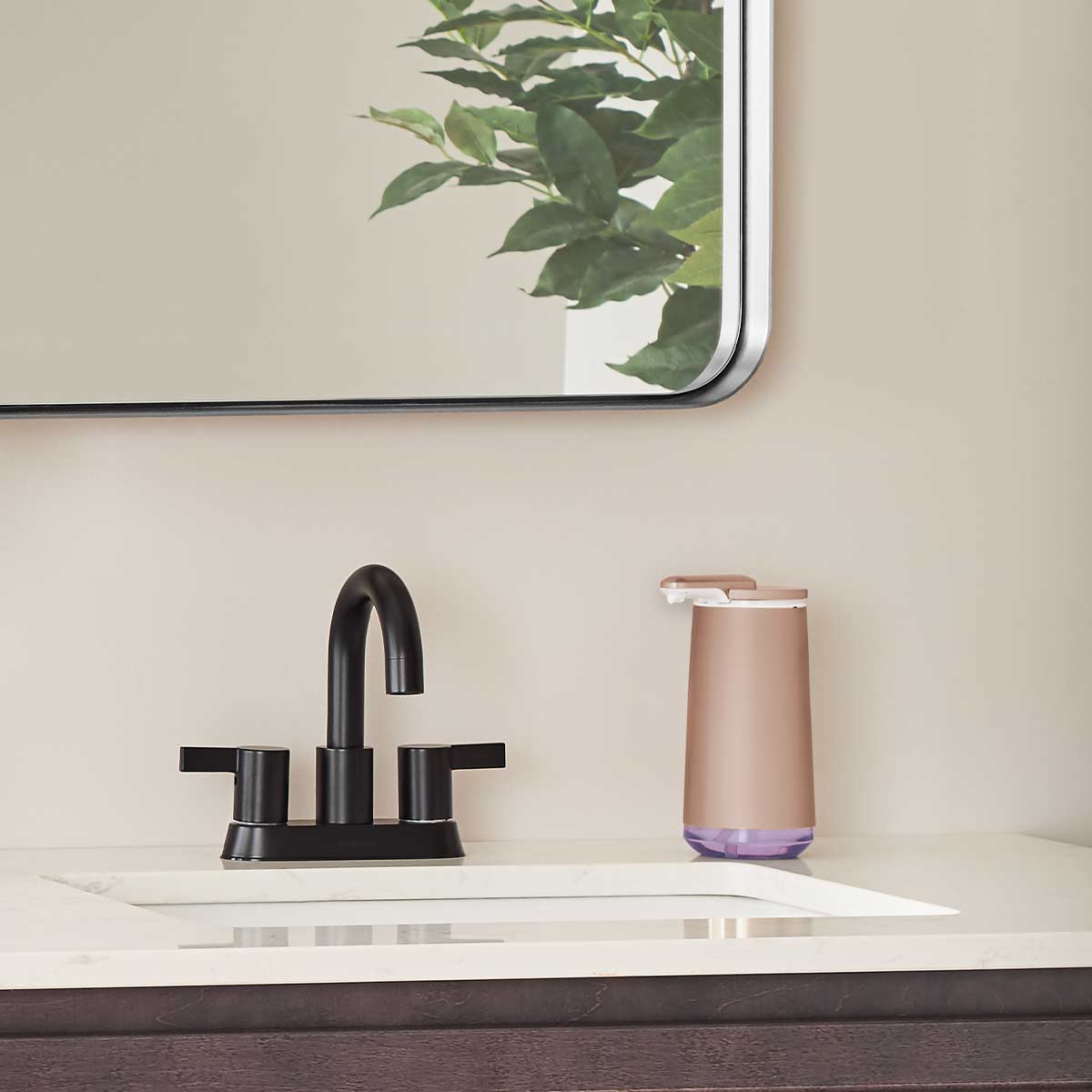 Lifestyle view of Simplehuman Rose Gold Foam Sensor Pump on a sink counter, touch-free automatic foaming.