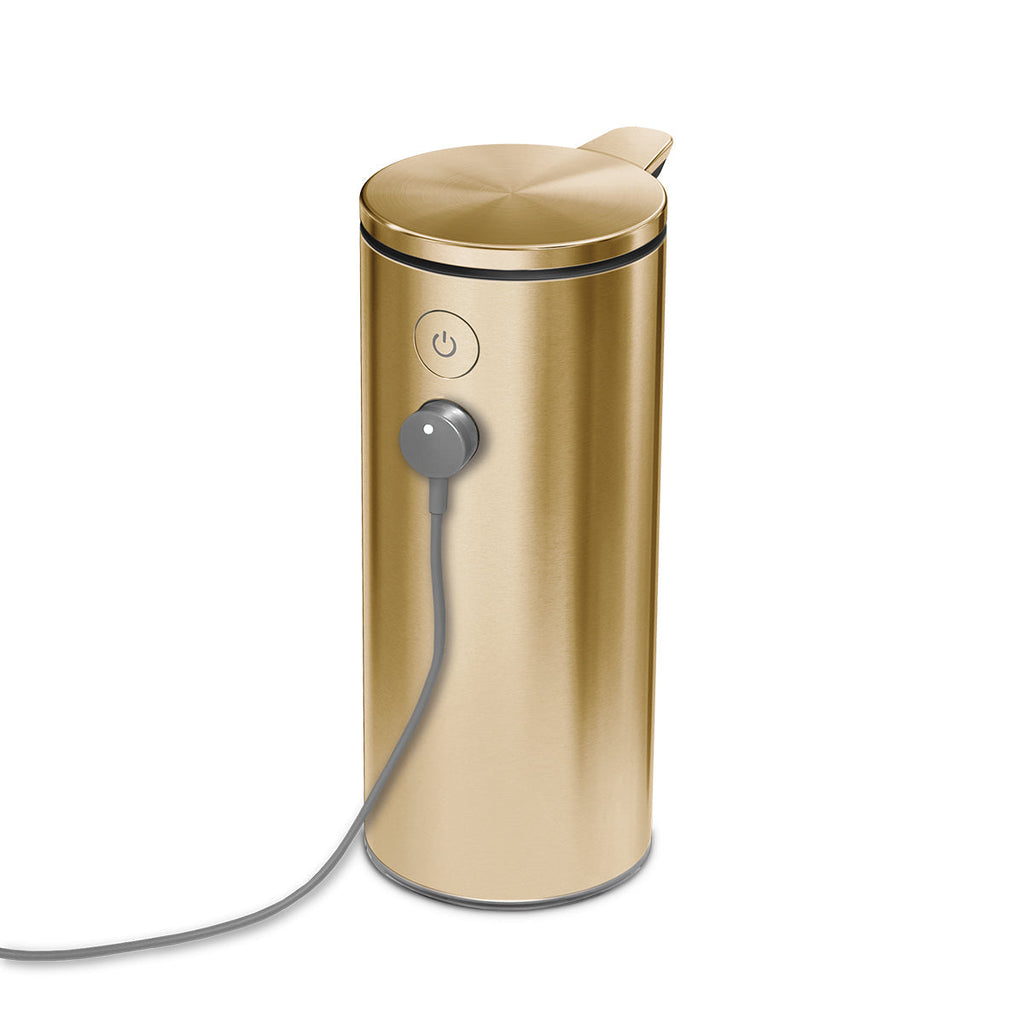 Detail view of Simplehuman 9 oz. Sensor Pump, Brass, showing magnetic charging connection.