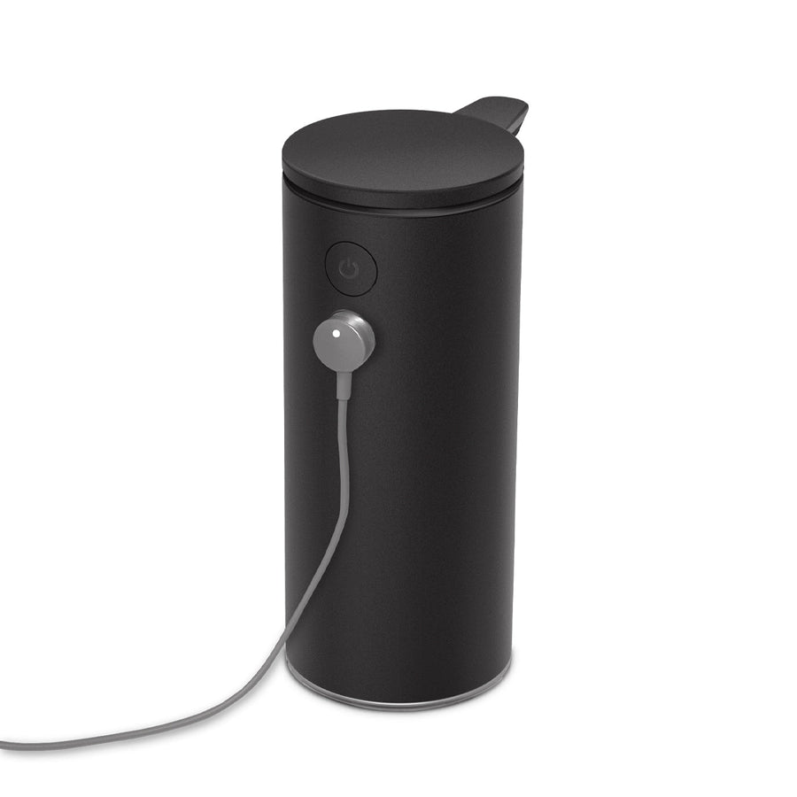 Close-up view of Simplehuman 9 oz. Sensor Pump in Matte Black, magnetic charging cable connected, rechargeable.
