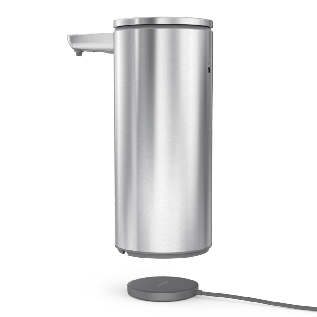 Simplehuman 14 oz. Sensor Pump in Brushed Stainless Steel above its magnetic charging pad, touch-free.