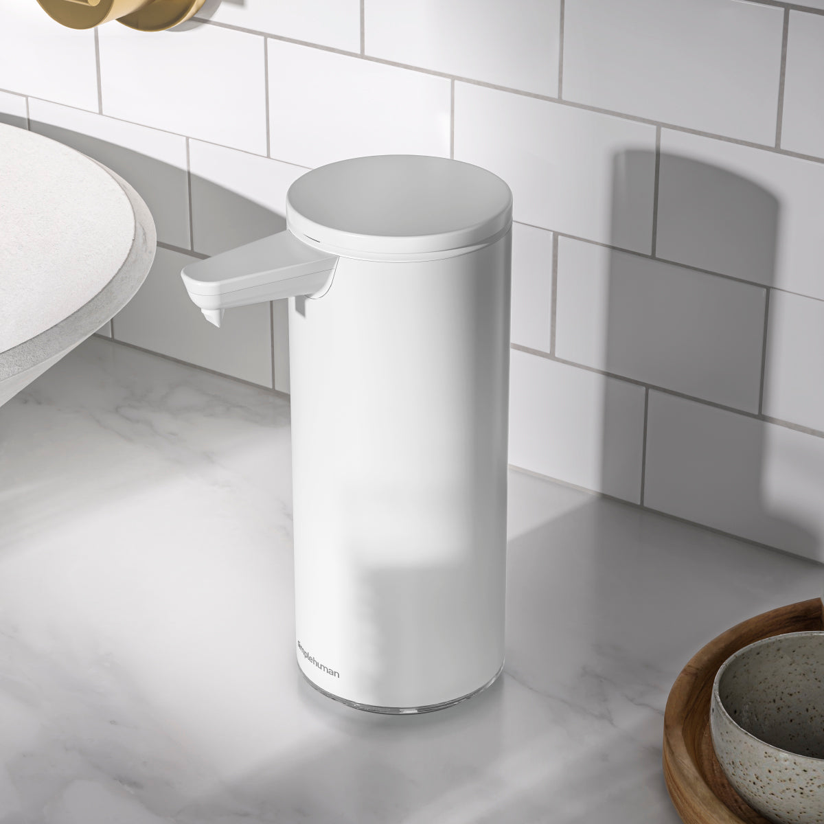 Simplehuman 9 oz. Sensor Pump, White, angled view on marble counter in modern bath or kitchen, touch-free.