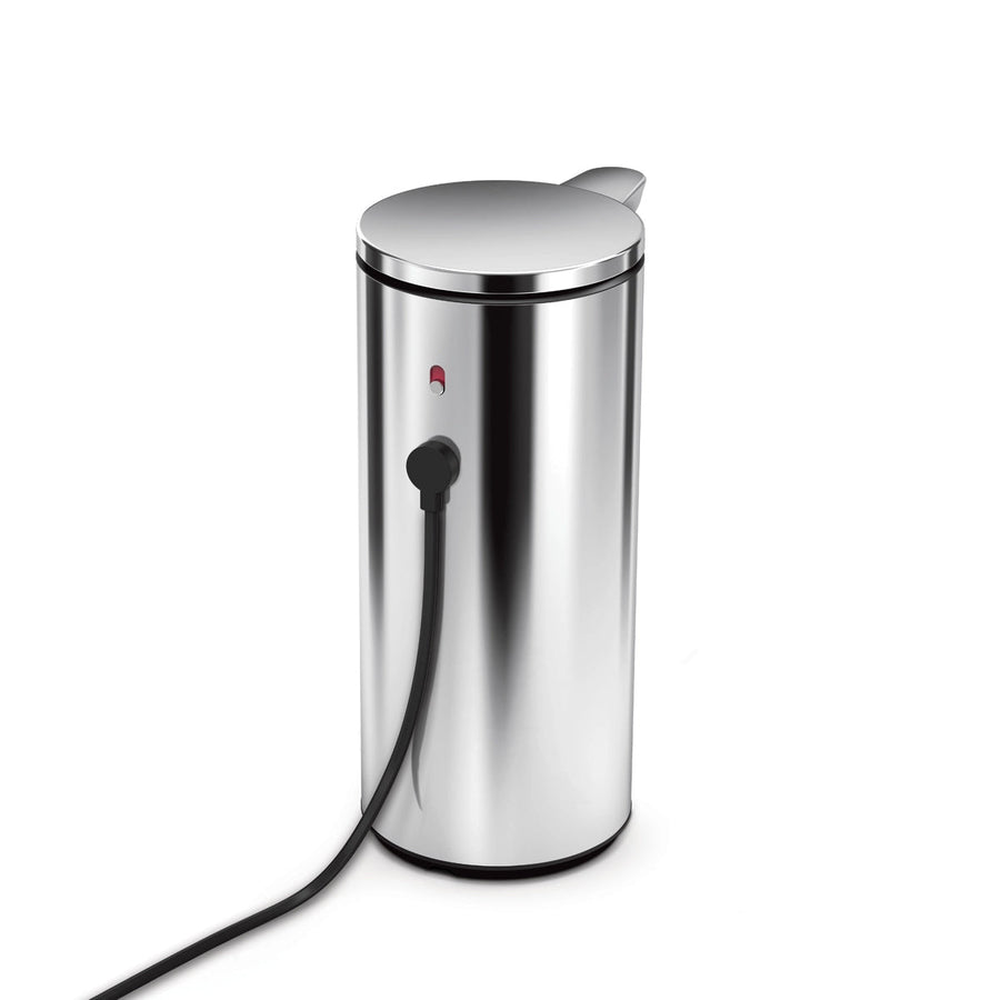 Simplehuman 9 oz. Sensor Pump, Brushed Stainless Steel, charging via magnetic port connection, red status light visible.