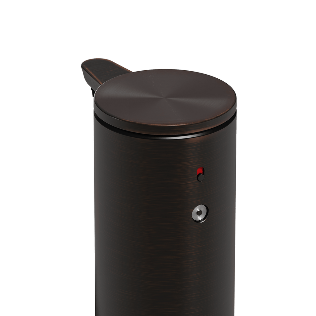 Detail view of Simplehuman 9 oz. Sensor Pump, Bronze, showing magnetic charge port and red power indicator.
