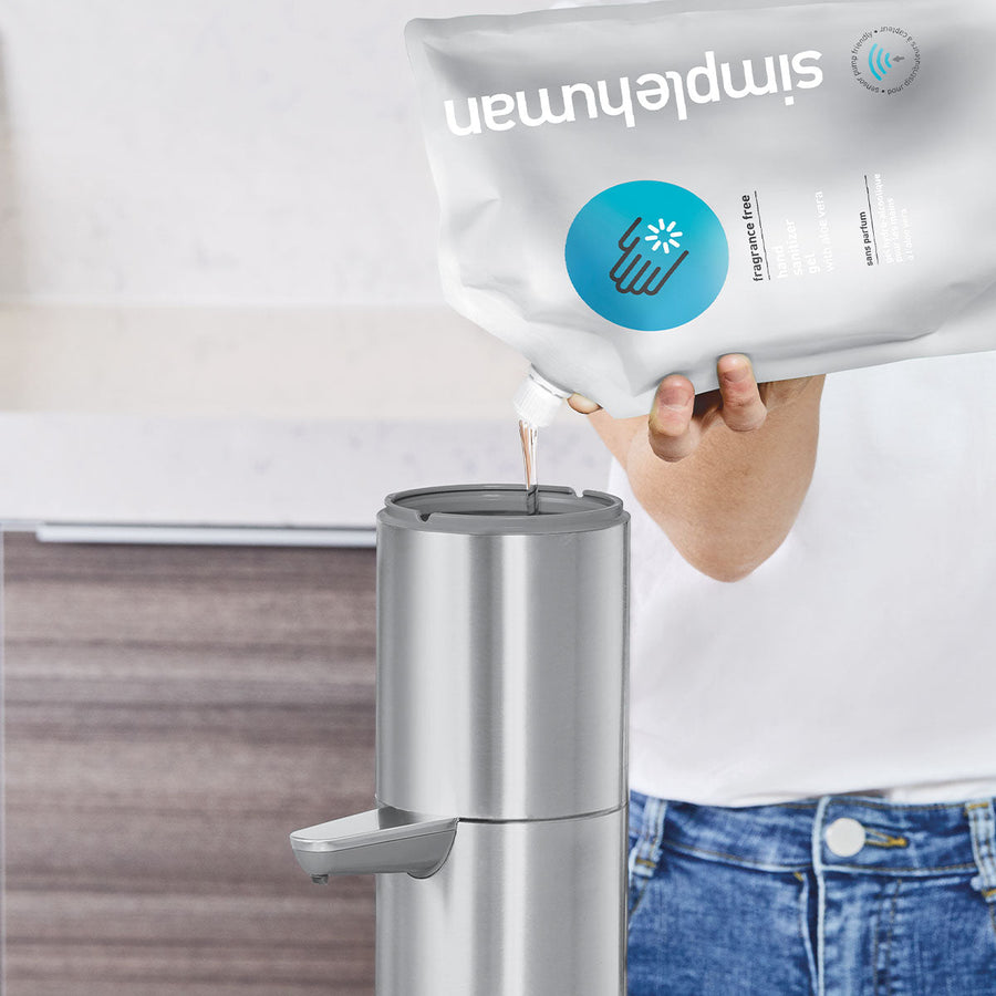 Detail view of Simplehuman Sensor Pump Max being refilled from a pouch, Brushed Stainless Steel, easy refill process.