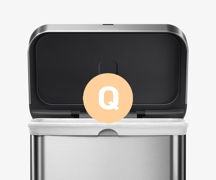 Simplehuman's Matte Gold Sensor Can showcasing that the can goes with their Code Q Custom Fit liner. This image features a large orange Q bubble within their can as well as a recycler bucket.