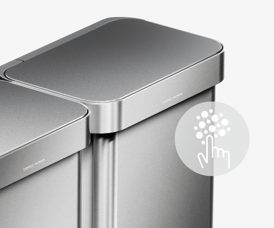 This image of Simplehuman's 90L Step Can in Brushed showcases an icon describing how the can has a silver ion-coating that resists both fingerprints and the spread of germs.
