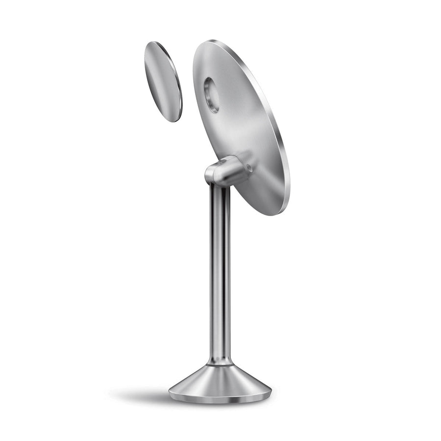 Angled detail of Simplehuman Sensor Mirror Pro Round, Brushed Stainless Steel, showing the detached magnetic zoom mirror.