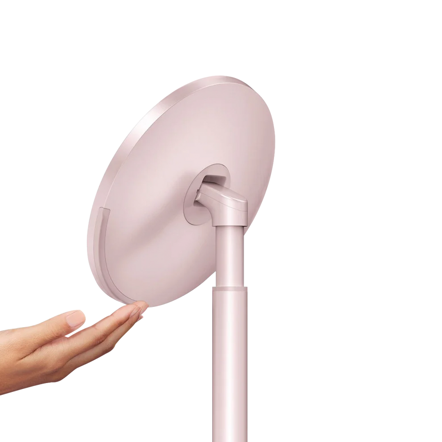 Side profile view, Simplehuman Rose Gold Sensor Mirror Round showing hand gesture activation for automatic light.
