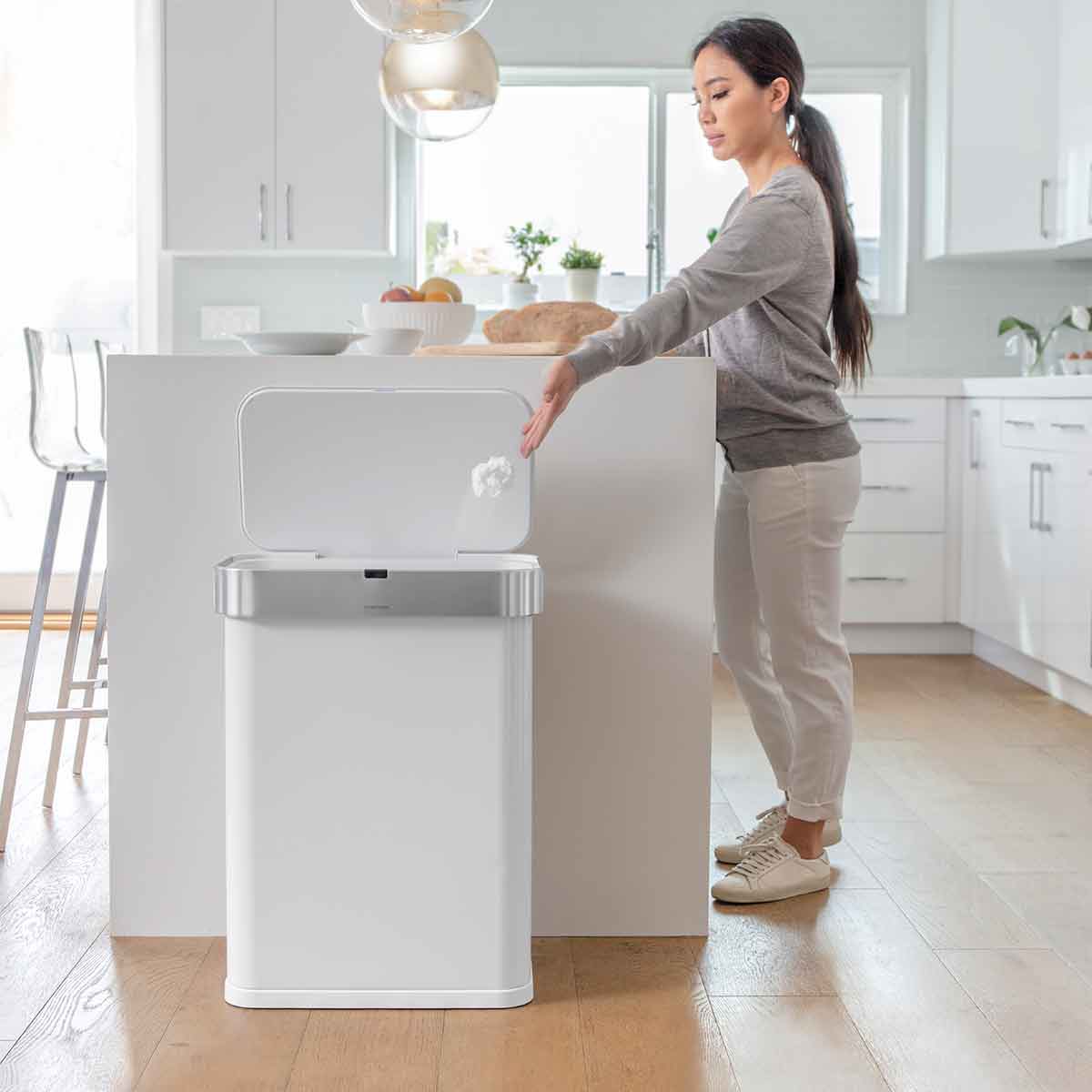 58L rectangular sensor can with voice and motion control - white steel - lifestyle woman throwing trash away