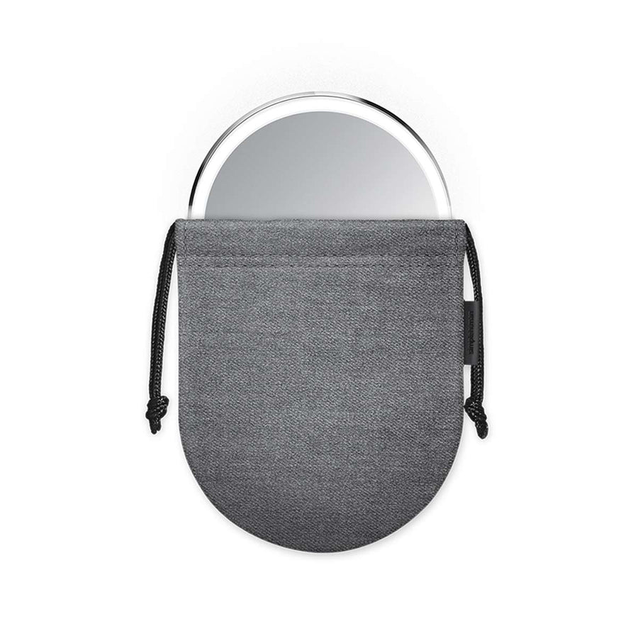 Simplehuman Sensor Mirror Compact 3x in Brushed Stainless Steel, illustrating portability within its protective pouch.