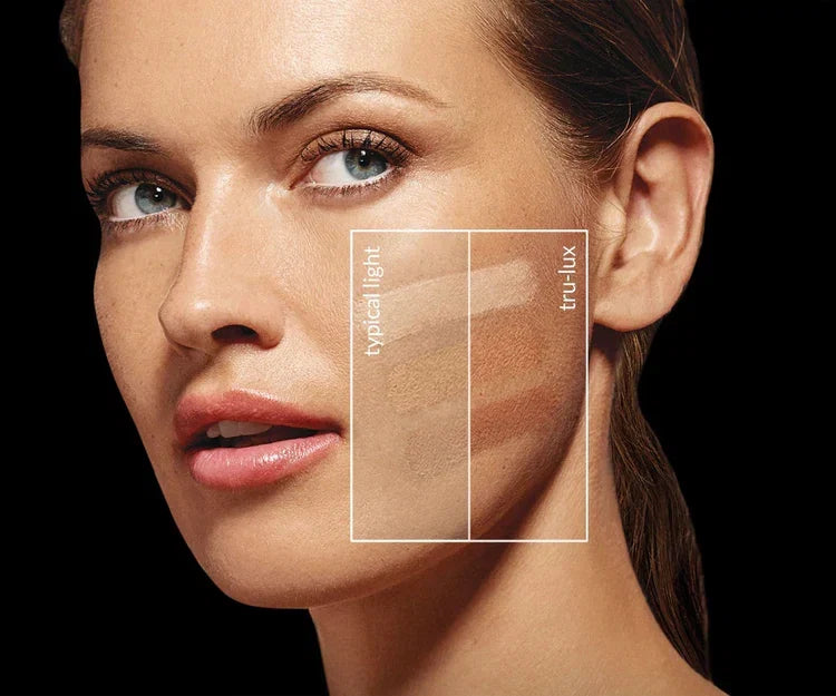 Woman's face with makeup swatches on a black background showcasing Simplehuman's Sensor Mirror Trio Max's ability to provide tru-lux lighting to help with makeup application.