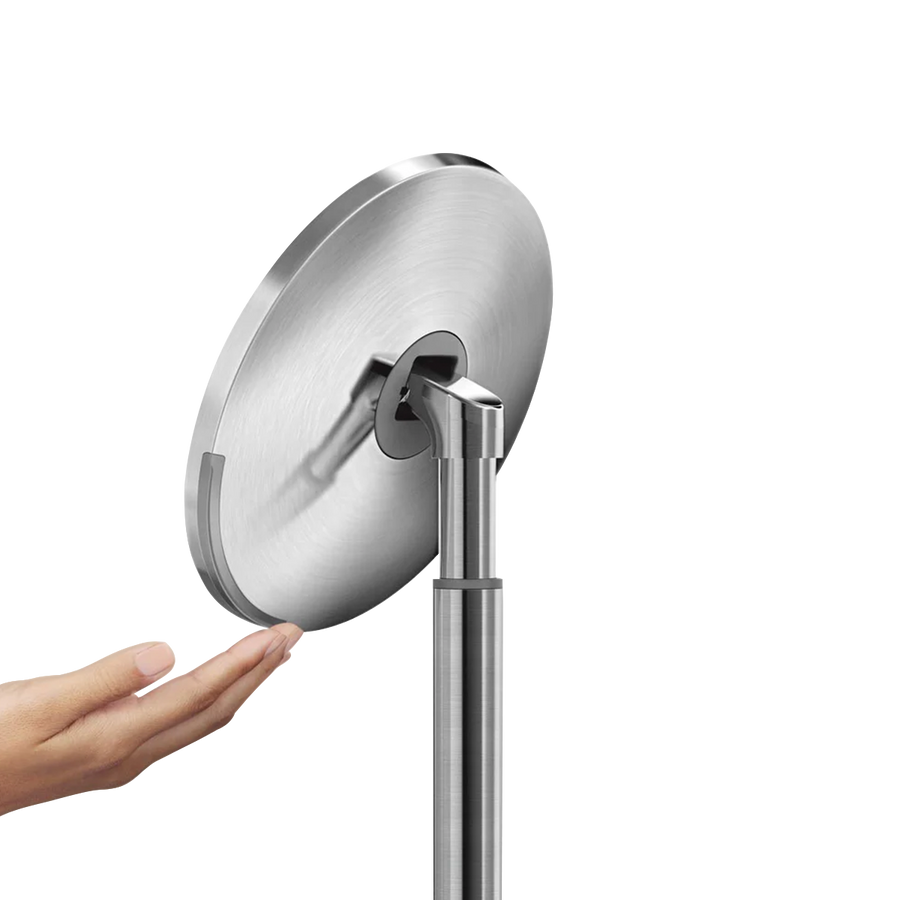Detail view of Simplehuman Sensor Mirror adjustable pivot and hand using the touch-control brightness feature.