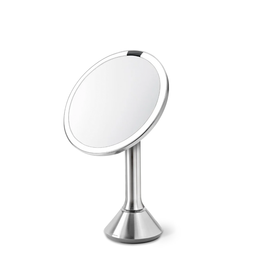 Angled view, Simplehuman Sensor Mirror Round in Brushed Stainless Steel with touch-control brightness and dual light system.