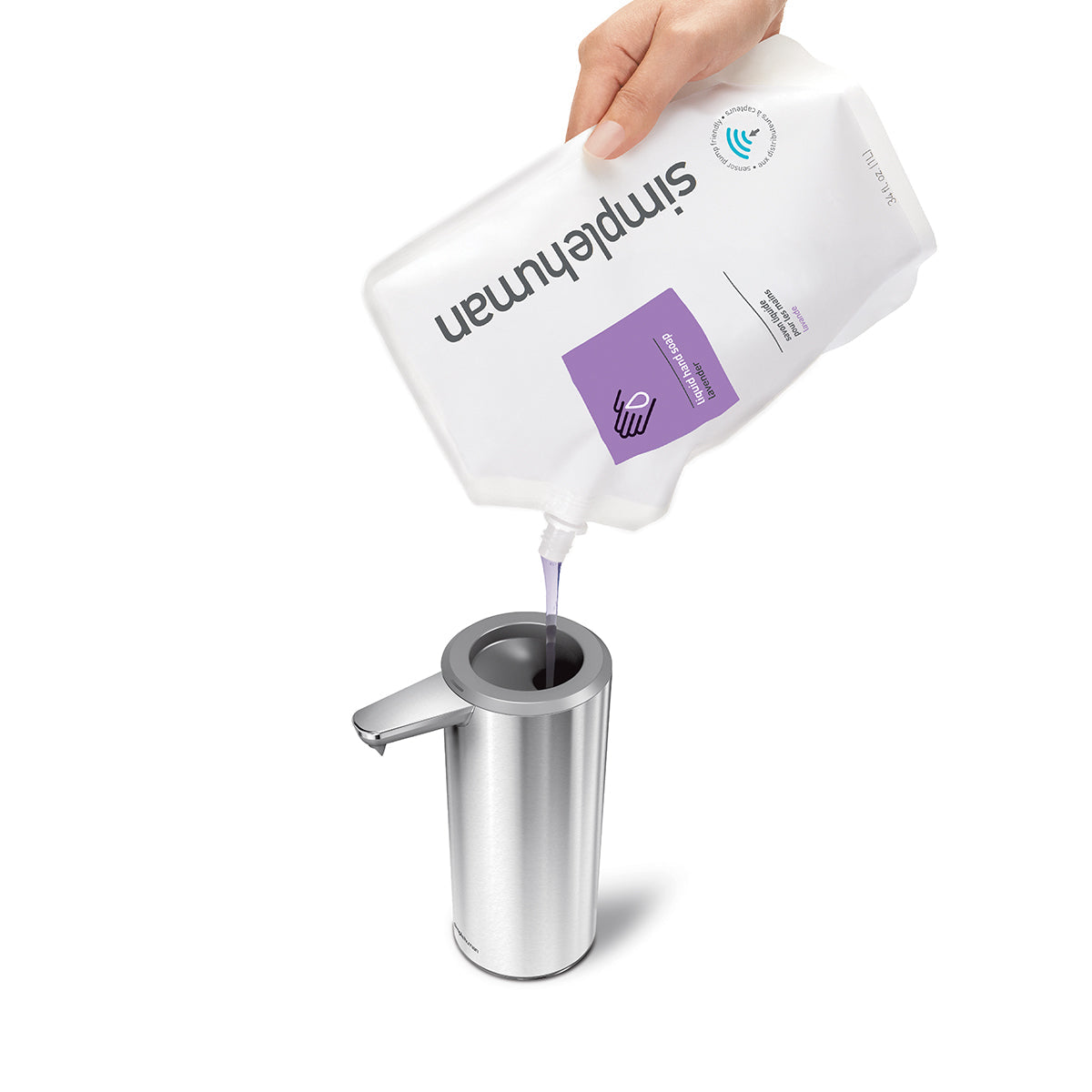 Simplehuman 9 oz. Sensor Pump in Brushed Stainless Steel being refilled with liquid soap pouch, wide opening for easy refill.