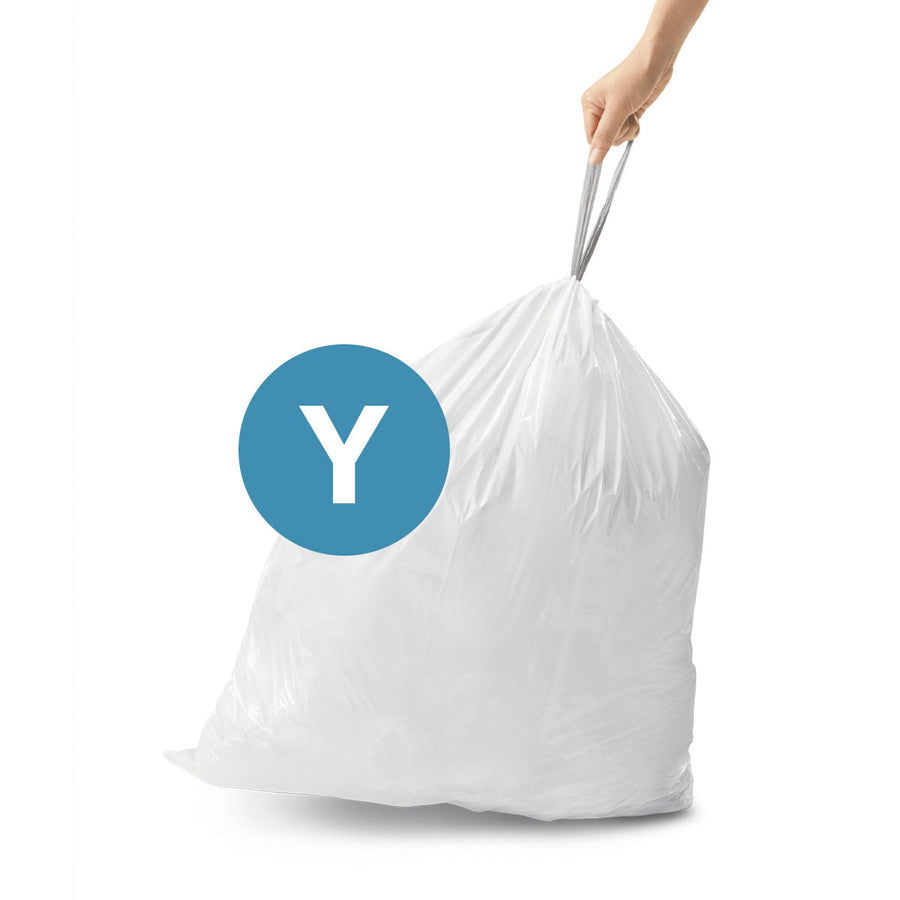 Usage shot of Simplehuman Code Y white Custom Fit Liner with strong drawstring handle for easy removal.