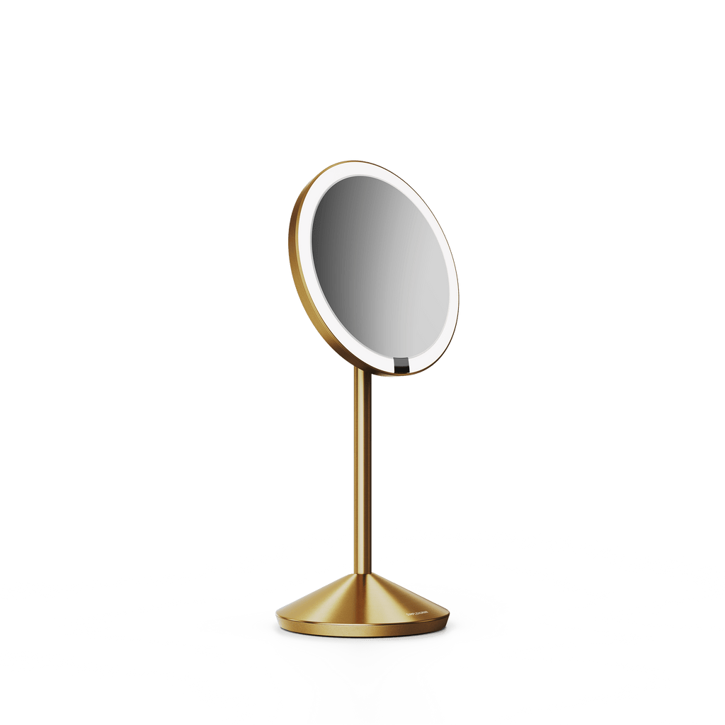 Simplehuman's Sensor Mirror Fold in Brass, angled view.