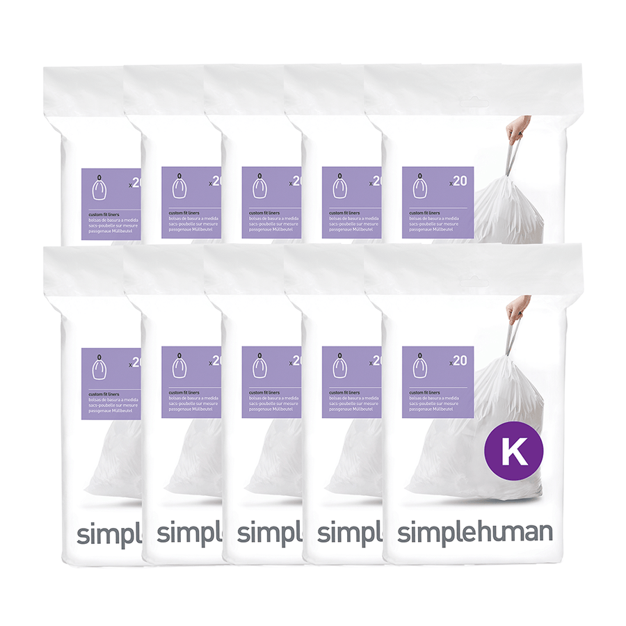 Bulk display of Simplehuman white Code K Custom Fit Liners (10 packs), featuring strong drawstring closure for easy removal.