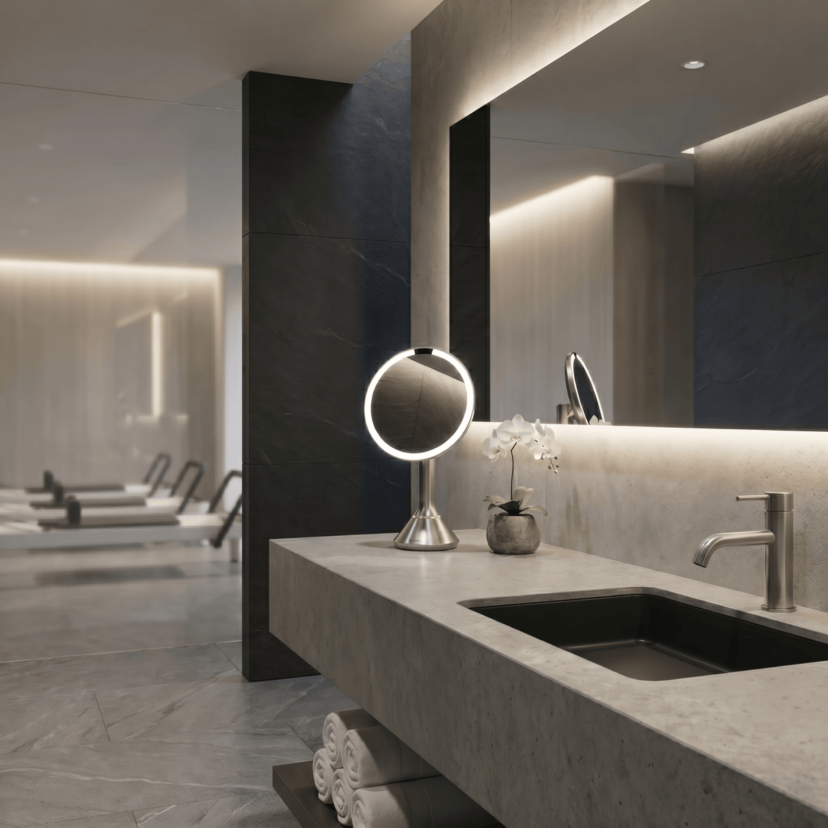 Simplehuman's Sensor Mirror Round in Brushed in a modern pilates studio bathroom setting