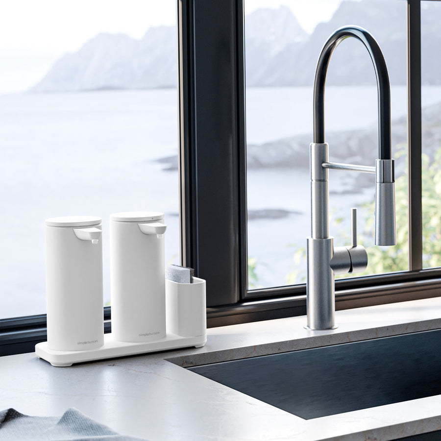 Lifestyle view of Simplehuman White Dual Caddy with two 14 oz sensor pumps by kitchen sink, hands-free organization.
